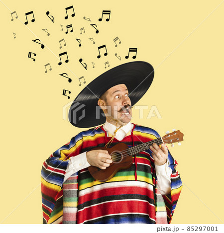 Contemporary art collage of cheerful man in mexican cloth having vinyl record sombrero playing ukulele isolated over yellow background Contemporary art collage of cheerful man in mexican cloth having vinyl record sombrero playing ukulele isolated over yellow background 85297001