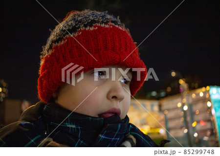 The boy looks into the distance on the background of the night city. High quality photo 85299748
