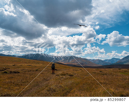 Solo hiking in the picturesque autumn mountain valley. Heavy climb in the mountains with a big backpack.Travel lifestyle, hiking hard track, adventure concept in autumn vacation. 85299807