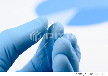 Scientist bend flexible transparent plastic like thin film material in laboratory 85300370