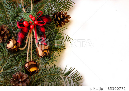 Christmas background. Spruce branches with cones and bells 85300772