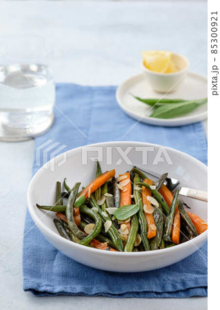 Green beans with carrots cooked with olive oil and sage. Healthy food. 85300921