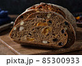 Slices of rye bread with hazelnuts and dried fruit like apricots, raisins and plums. 85300933