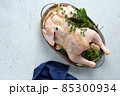 Fresh Raw chicken with herbs sage, rosemary, oregano. Top view. 85300934