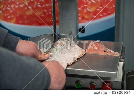 Service for cutting fish on a steak in a fish supermarket Service for cutting fish on a steak in a fish supermarket 85300954