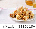 Crepes, thin pancakes with honey and tea on a white plate. 85301160
