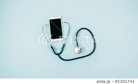 Telemedicine or telehealth virtual visit, video visit, remote doctor video chat consultation concept with smartphone, open notepad and stethoscope on blue background Telemedicine or telehealth virtual visit, video visit, remote doctor video chat consultation concept with smartphone, open notepad and stethoscope on blue background 85302743