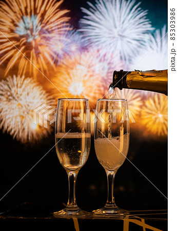 two champagne glasses against fireworks  New Year's eve celebration 85303986