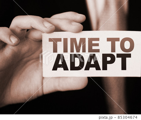Time To Adapt on a card in businessman had. Business crisis management concept 85304674