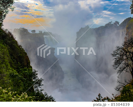 Victoria Falls with water dust and fog in the morning at sunrise 85304839