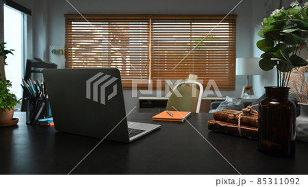 Mock up laptop computer, books n potted plant on black table in home office. Mock up laptop computer, books n potted plant on black table in home office. 85311092