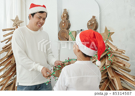 Father and Son Decorating Tree 85314507