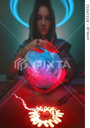 Predictable Caucasian woman with globe planet in her hands and luminous pictogram on the table. Astrology applied magic and mysticism. Focus on the texture of the ball. Clairvoyant out of focus Predictable Caucasian woman with globe planet in her hands and luminous pictogram on the table. Astrology applied magic and mysticism. Focus on the texture of the ball. Clairvoyant out of focus 85314552