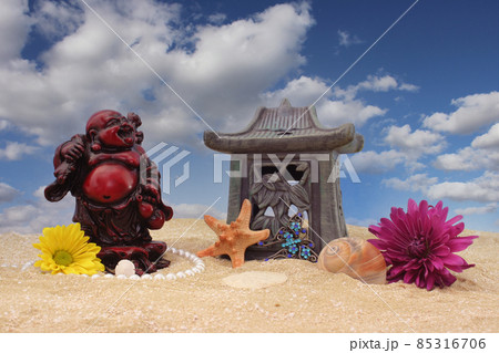 Flowers with Sea Shells and Buddha on Sand With Blue Sky Background Flowers with Sea Shells and Buddha on Sand With Blue Sky Background 85316706