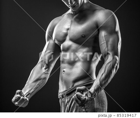 Image of very muscular man posing with naked torso Image of very muscular man posing with naked torso 85319417