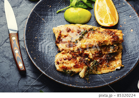 Fried fish fillets in orange oil. 85320224