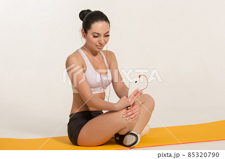 Brunette with fit body on yoga mat 85320790