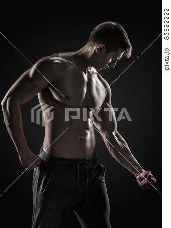 Strong man showing perfect abs, houlders, biceps, triceps and chest Strong man showing perfect abs, houlders, biceps, triceps and chest 85322222