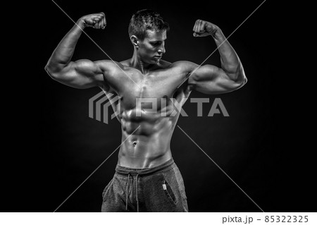 Fitness man model torso posing and showing perfect body Fitness man model torso posing and showing perfect body 85322325
