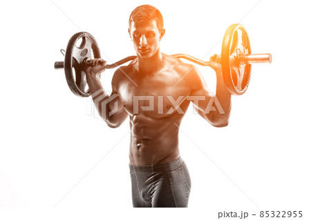 Strong man exercising fitness body building exercises with a barbell Strong man exercising fitness body building exercises with a barbell 85322955