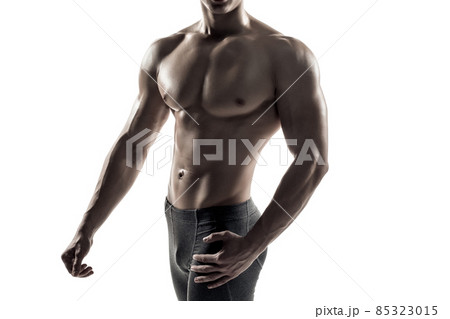 Strong man showing perfect body, abs and chest. Close-up 85323015