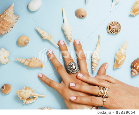beautiful woman hands with pink manicure holding plate with pearls and sea shells, luxury jewelry concept beautiful woman hands with pink manicure holding plate with pearls and sea shells, luxury jewelry concept 85329054