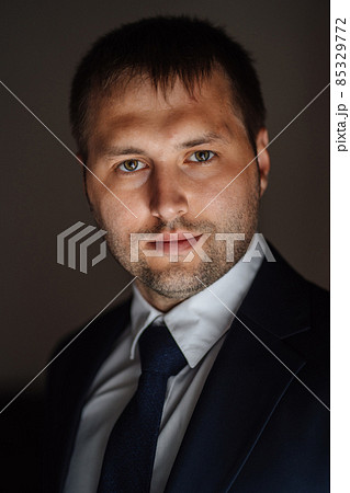 portrait of a man in a white shirt, jacket and tie  85329772