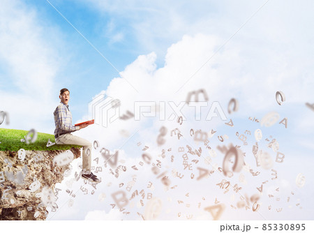 Student guy in suit with book in hands preparing for exam 85330895