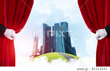 Modern cityscape behind drapery curtain and hand opening it Modern cityscape behind drapery curtain and hand opening it 85331041