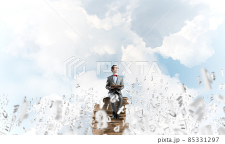 Young businessman or student studying the science and symbols fly around 85331297