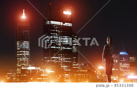 Woman looking at night city Woman looking at night city 85331306