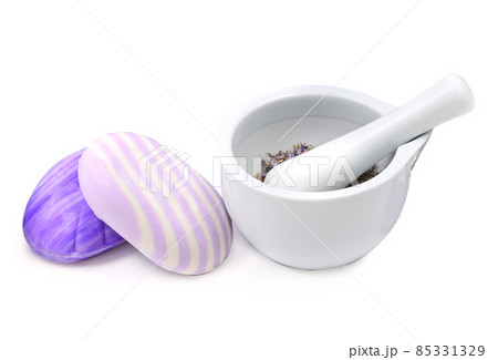 Lavender soap and dry lavender flowers in a mortar isolated on a white . Lavender soap and dry lavender flowers in a mortar isolated on a white . 85331329