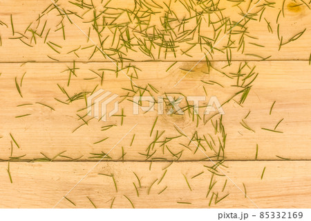 New Year's green spruce with crumbling needles on wooden background. End of the new year and holidays concept New Year's green spruce with crumbling needles on wooden background. End of the new year and holidays concept 85332169