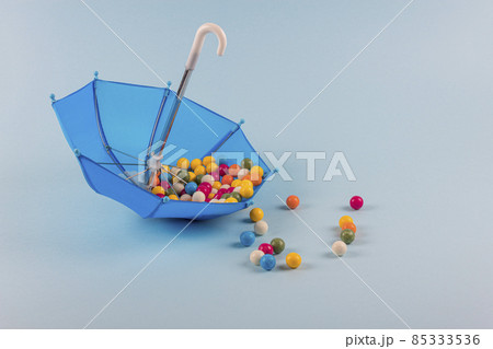 Upturned umbrella with caramel candy. Concept for Dia de Reyes Magos day (Three Wise Men) or Epiphany day. Upturned umbrella with caramel candy. Concept for Dia de Reyes Magos day (Three Wise Men) or Epiphany day. 85333536