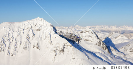 Aerial Panoramic View of Canadian Mountain covered in snow Aerial Panoramic View of Canadian Mountain covered in snow 85335498