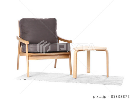 Comfortable armchair with coffee table and rug isolated on white Comfortable armchair with coffee table and rug isolated on white 85338872