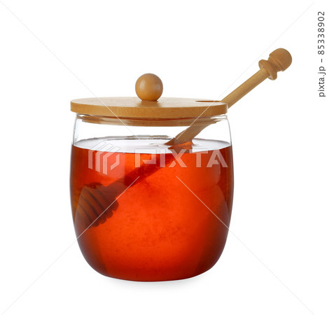 Jar with organic honey and dipper isolated on white Jar with organic honey and dipper isolated on white 85338902