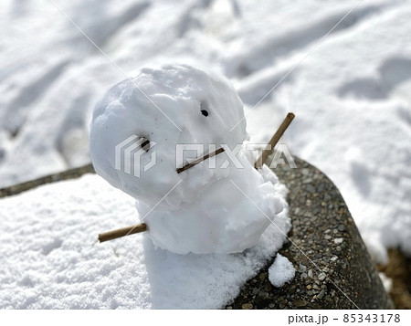 日の光を浴びる小さな雪だるま 85343178