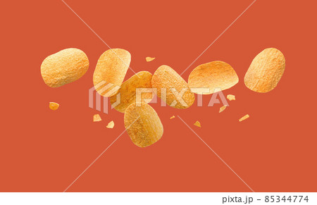 Potato chips flying on a red background. 85344774