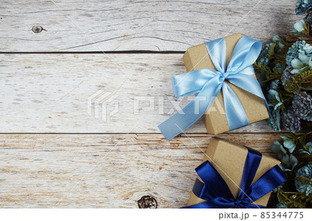 Gift boxes with blue ribbon on wooden background Gift boxes with blue ribbon on wooden background 85344775