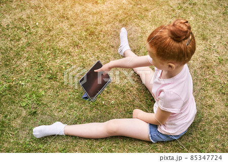 Pretty face. Red hair. Cute school child doing yoga exercise. Active vacation 85347724