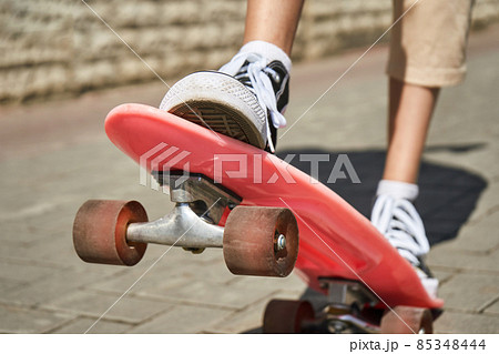 Girl with skateboard. Town landscape. Black sneakers. New normal travel 85348444