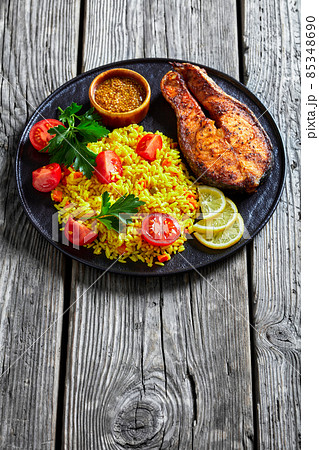 oven baked salmon steak with yellow rice oven baked salmon steak with yellow rice 85348690