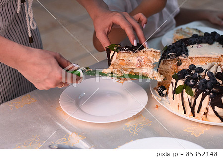 a cut piece of cake is placed on a plate. 85352148