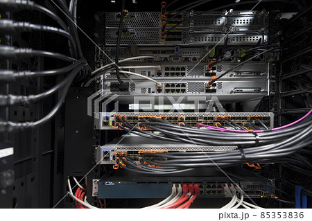 network server room closeup on fiber optic hub or switch for digital communications and internet in mainframe corporate business data center supercomputer. network server room closeup on fiber optic hub or switch for digital communications and internet in mainframe corporate business data center supercomputer. 85353836