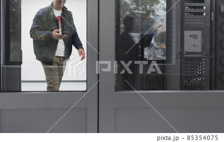 Technicians team updating hardware inspecting system performance in super computer server room or cryptocurrency mining farm. 85354075