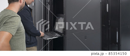 Technicians team updating hardware inspecting system performance in super computer server room or cryptocurrency mining farm. Technicians team updating hardware inspecting system performance in super computer server room or cryptocurrency mining farm. 85354150