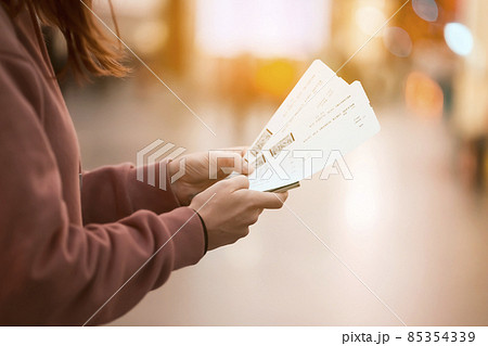 Girl holds tickets, boarding passes for a flight. Girl holds tickets, boarding passes for a flight. 85354339