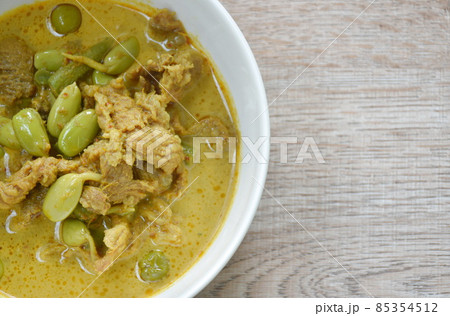 spicy boiled pork and Nitta tree seed or luk rieng in coconut milk curry soup Thai southern food on bowl 85354512