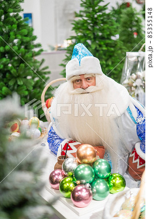 Russian santa claus holds decorations for the christmas tree in the store. 85355148